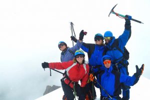 Team pose at the top of a peak