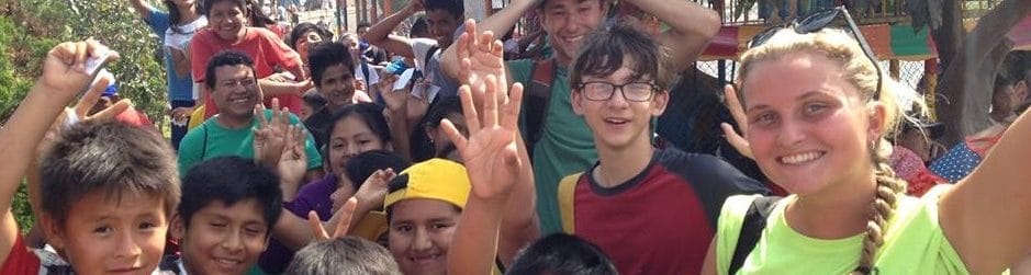 Quest Overseas Volunteers with local community children in the shanty town of lima